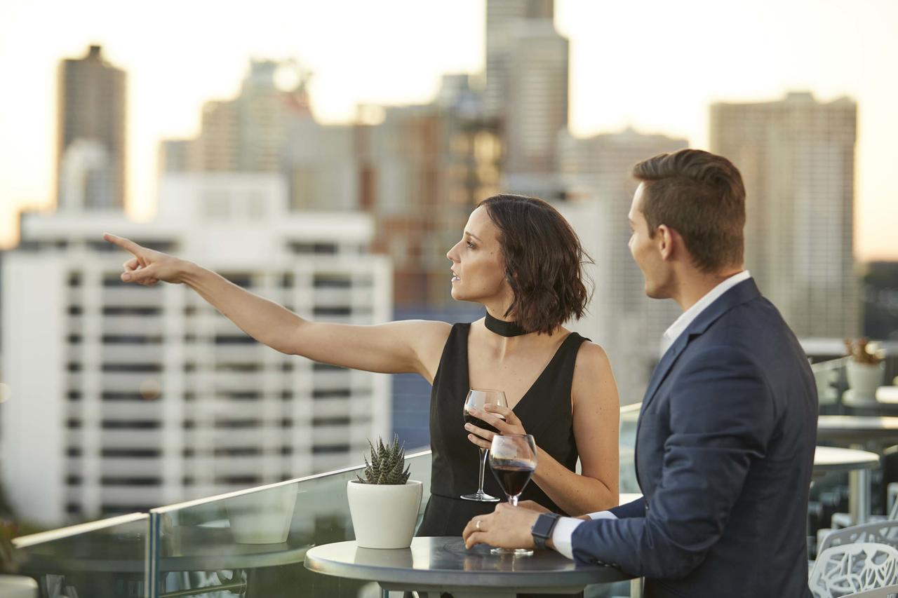 The Point Brisbane Hotel Bagian luar foto A couple at a rooftop party